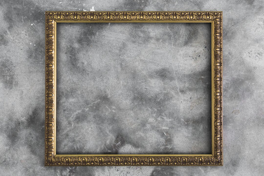Gold picture frame on concrete background - horizontal