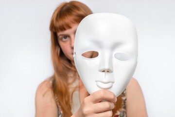 Mysterious woman cover her face behind anonymous mask