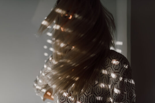 Close up of a blonde woman in laced shirt