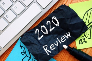 Financial concept about 2020 Review with inscription on the sheet.