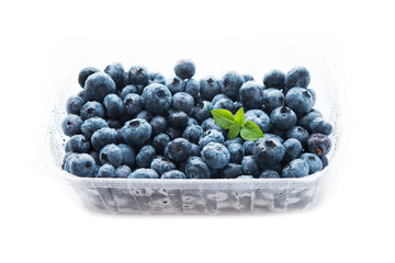 Fresh summer blueberry in a white Cup isolated on a white background