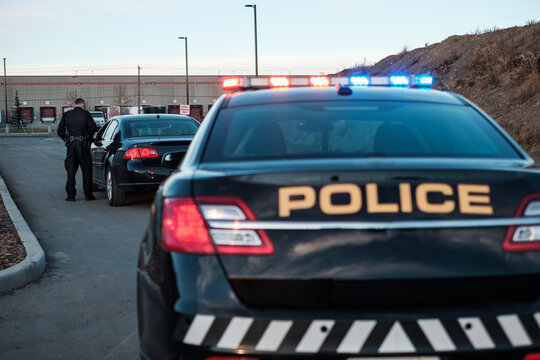 A Police Officer speaks to a driver during a traffic stop