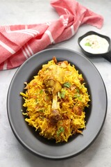 Chicken Biryani/murg Pulao.  Garnished with fried onion & chopped coriander. Biryani raita is a famous Spicy non vegetarian dish of India. Chicken cooked along with Basmati rice & spices. copy space.