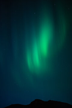 Northern lights behind mountains