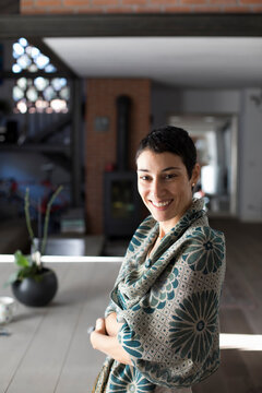 Portrait of smiling woman in her house