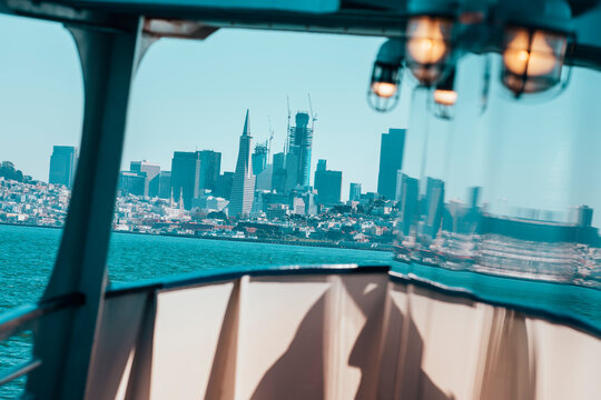 San Francisco looms on the horizon from the deck of a boat