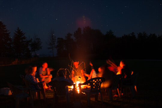 Campers around a campfire at night
