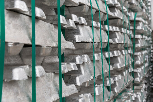 Stacked alumninium ingots in warehouse awaiting delivery