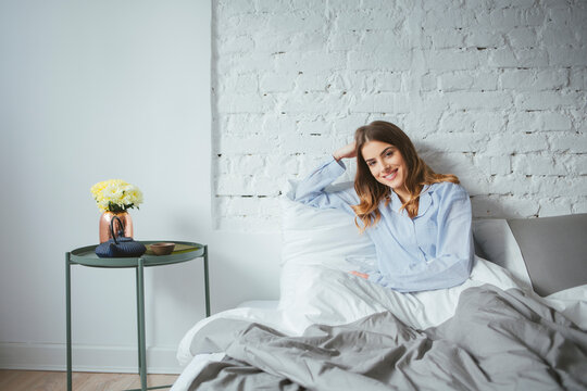 Portrait of Beautiful Woman Sitting on Her Bed