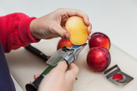 Technician measuring fruit mellowness with a refractometer