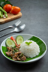 thai food ;Stir-fried pork with kaffir lime leaves serve with rice