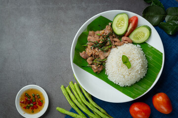thai food ;Stir-fried pork with kaffir lime leaves serve with rice