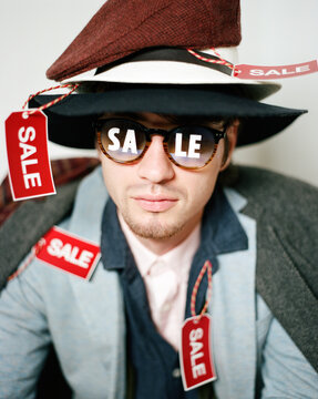 Man wearing clothing with sale labels