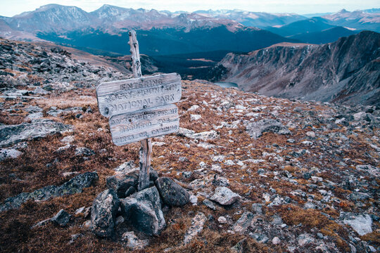 A crude wooden sign marks the boundary of Rocky Mountain National Park