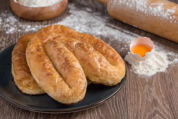 Traditional Turkish Borek or Turkish pastry with minced meat, cheese and spinac on wooden background
