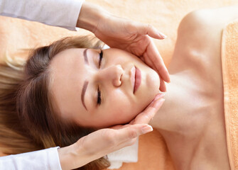 Obraz na płótnie Canvas Beautiful woman receiving massage from female therapist in spa. Beauty wellness concept