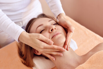 Fototapeta na wymiar Beautiful woman receiving massage from female therapist in spa. Beauty wellness concept