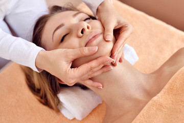 Beautiful woman receiving massage from female therapist in spa. Beauty wellness concept