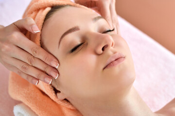 Beautiful woman receiving massage from female therapist in spa. Beauty wellness concept