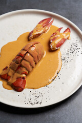 Seafood lobster with soup sauce. Cooked lobster on restaurant table, close-up