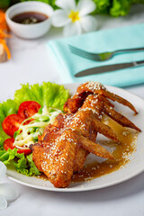 Fried chicken wings with fish sauce and sweet fish sauce.