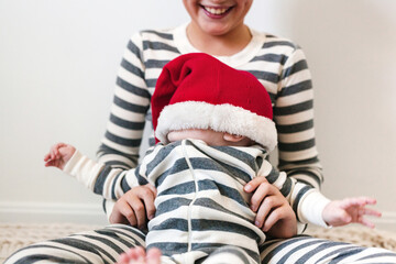 santa hat has fallen over baby's face during family portrait