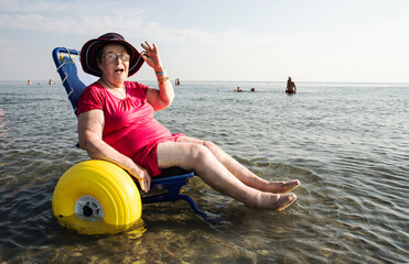 Senior lady on a special wheelchair for the beach