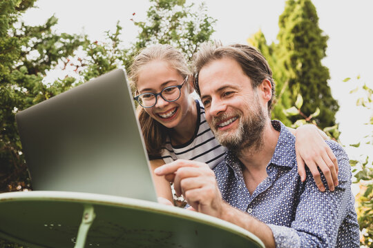 Caucasian Father And Daughter Having Video Chat On Laptop Computer