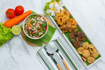 Mixed Spicy Salad with Vietnamese Sausage, Preserved Egg and Crispy Squid, Thai Food.