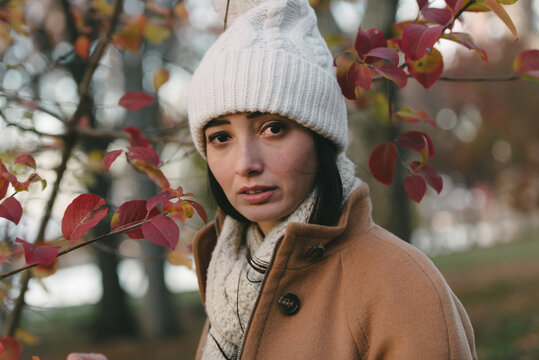 Young woman in red leaves
