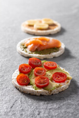 Assortment Puffed rice cake snack on gray stone