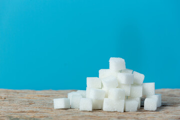 World diabetes day;pile of sugar cubes on blue background