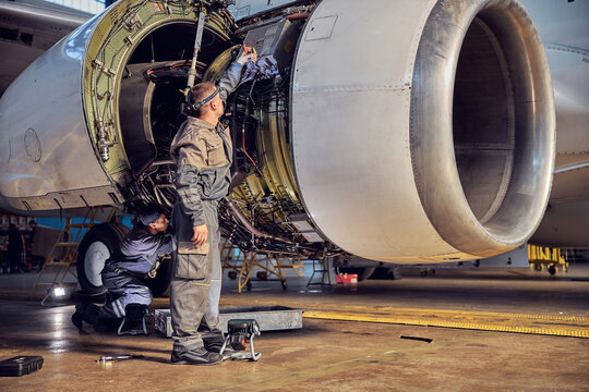View of airplane and engine mechanisms on the wing in the indoors