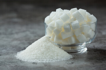 World diabetes day;Sugar cubes in a glass bowl on dark floor