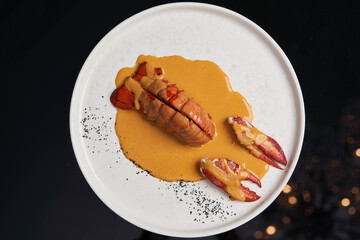 Seafood lobster with soup sauce. Cooked lobster on restaurant table, close-up