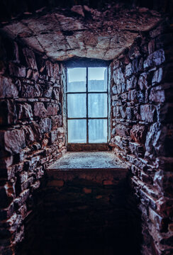 Stone house. Dark room with window