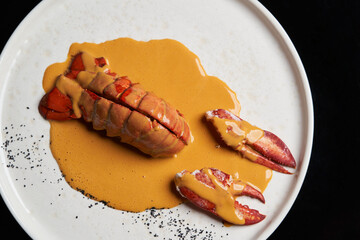 Seafood lobster with soup sauce. Cooked lobster on restaurant table, close-up