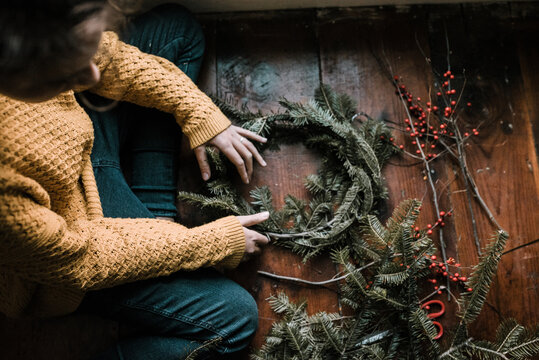 young woman making a wreath