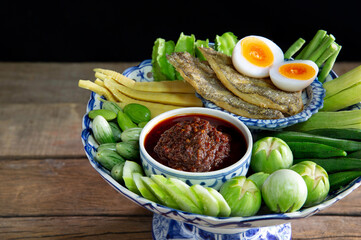 Fried chili paste, eaten with vegetables and fried fish, with boil egg (thai called  nam prik pao), Thai food on tile tray