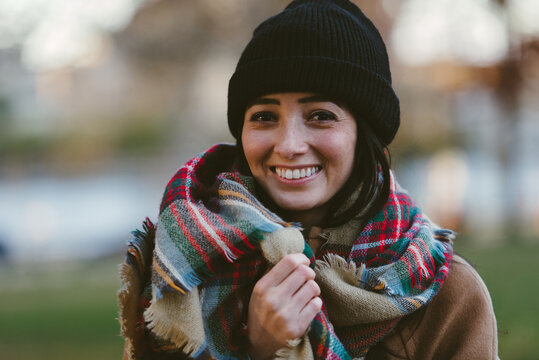Happy woman in plaid scard