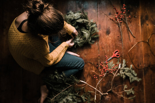 young woman making a wreath