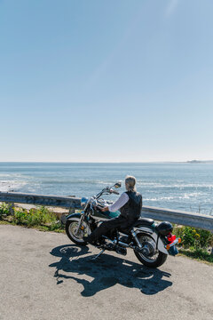 Motorcycle Rider relaxing by Beach