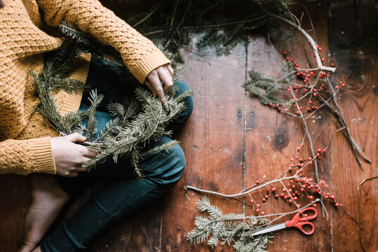 young woman making a wreath