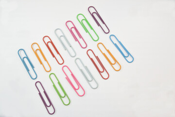 A set of colored paper clips laid out in two rows under each other