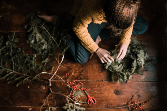 young woman making a wreath