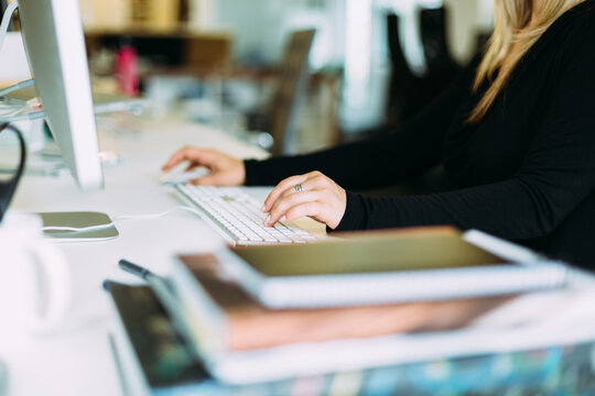Woman Sitting At Office Desk, Navigating With Mouse and Keyboard