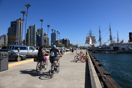 People are walking and bike ride along the walkway of San Diego Bay California, USA