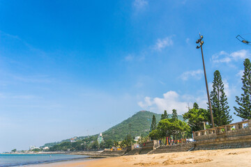 park in front beach of Vung Tau city with waves, coastline, streets, coconut trees and Tao Phung mountain in Vietnam
