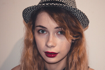 Close up portrait of beautiful fashion girl with hat and red lipstick