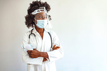 Young female doctor is measuring your body temperature with a digital infrared thermometer. Shot of...